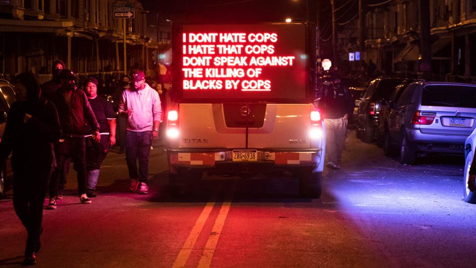 A truck displays a sign as protesters march in West Philadelphia on October 27, 2020, to demonstrate against the fatal shooting of 27-year-old Walter Wallace, a Black man, by police. (AFP)
